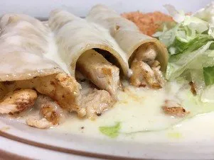 Enchilada Grill topped with cheese sauce, served with rice and salad