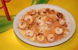 Shrimp and rice smothered in cheese sauce with lettuce and tomato